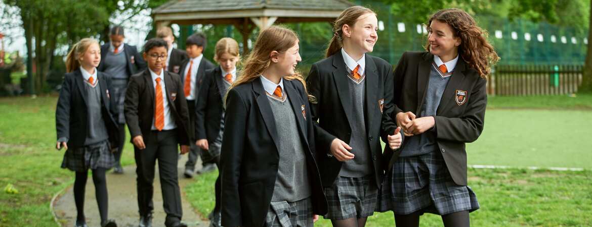 Beacon Academy students walking in groups of three across the school's Year 7 area
